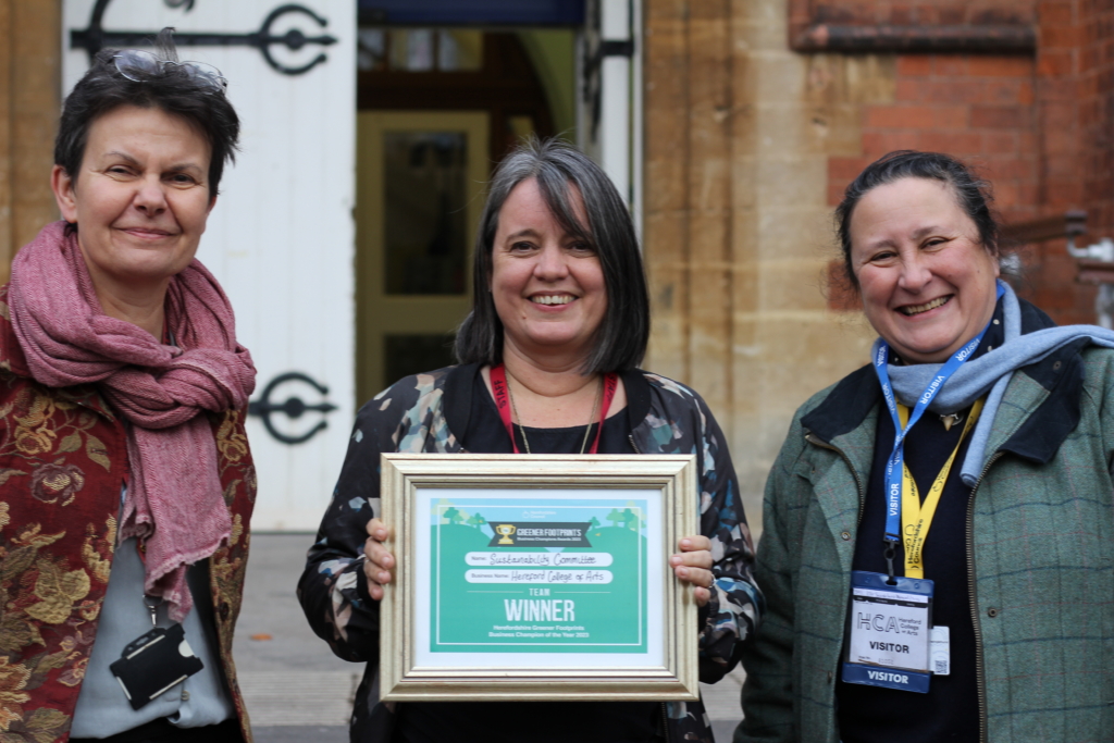 Abigail Appleton ( left) and Jess Bugler (centre) receive their award from Cllr Swinglehurst - Picture: Greener Footprints